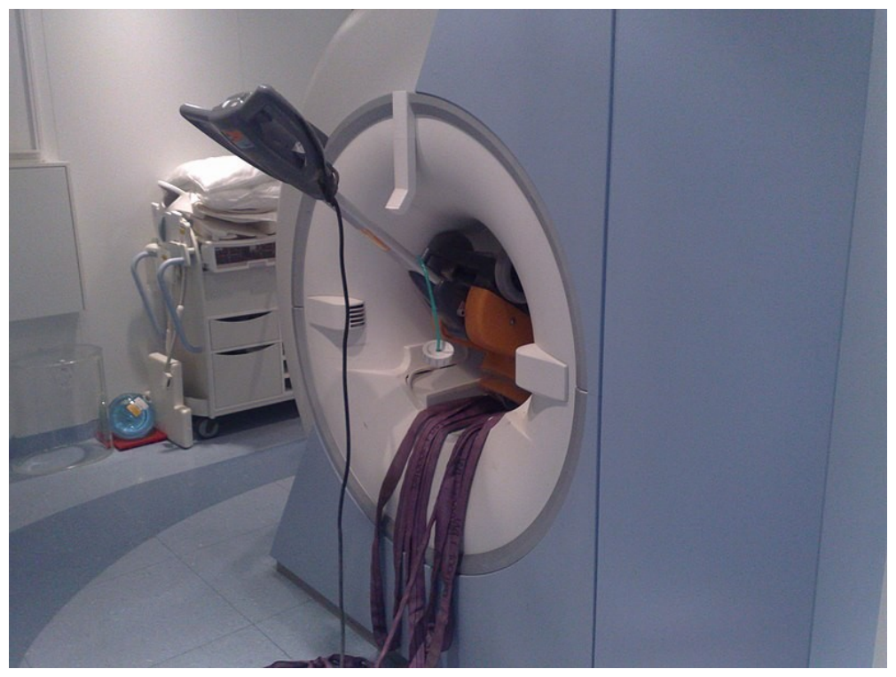 A floor cleaning machine pulled into the bore of an MRI scanner and stuck against the magnet opening