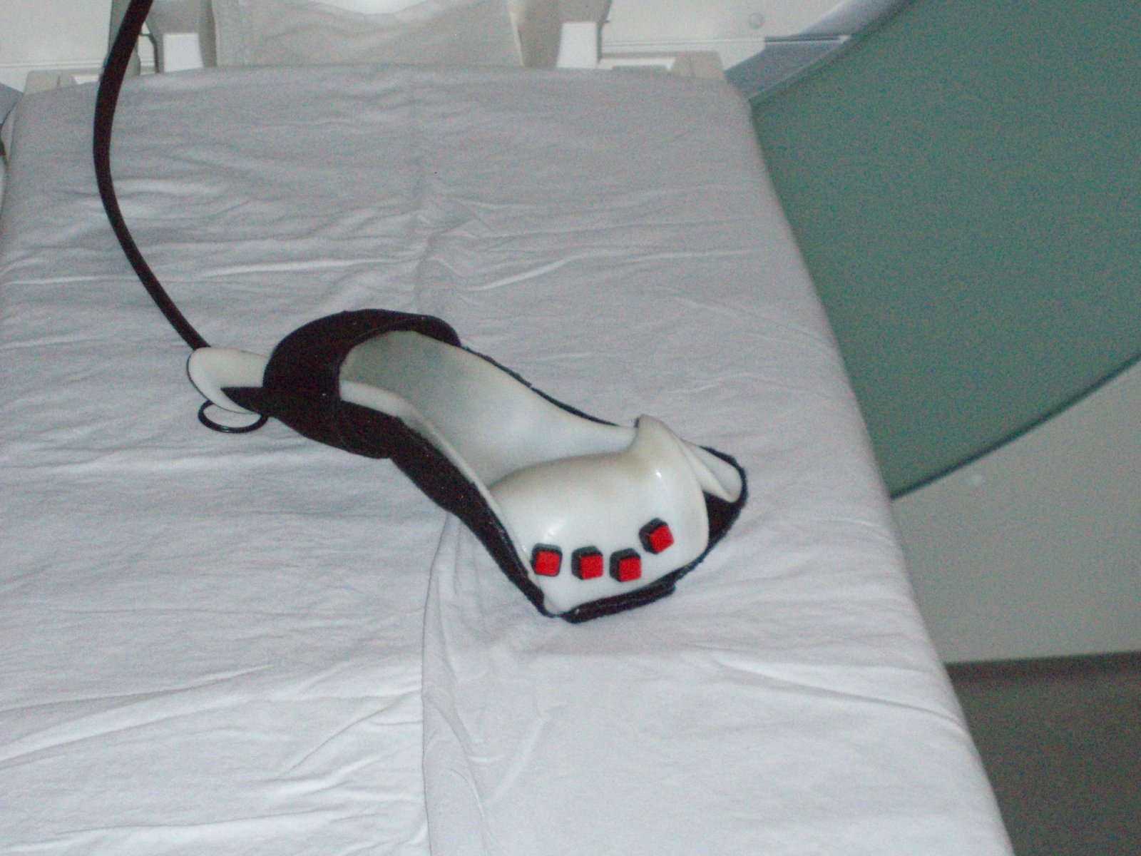 MRI-compatible response glove on the scanner bed